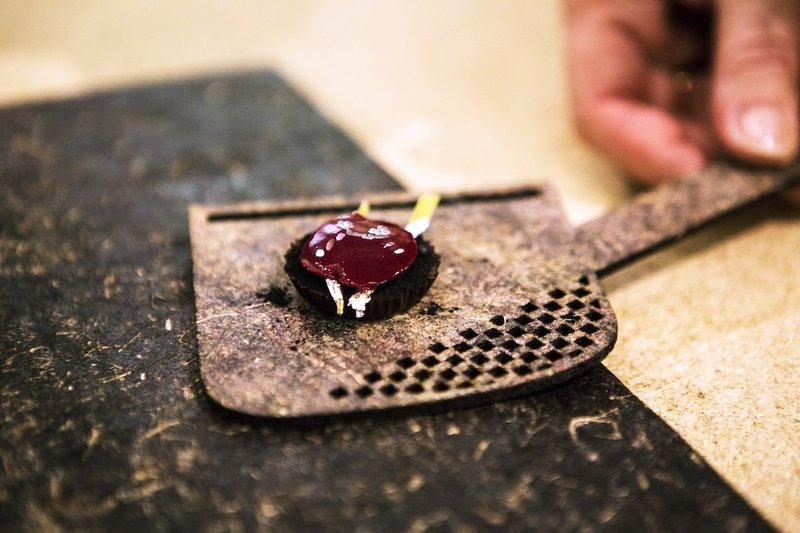 Aronia-based edible solar cell on a linen board. Photo by Micha Haller
